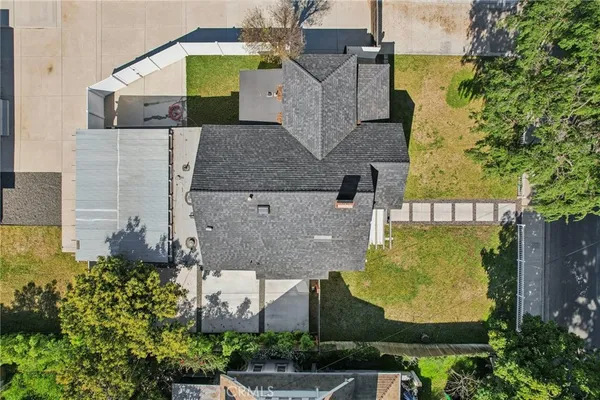 an aerial view of a house with a swimming pool