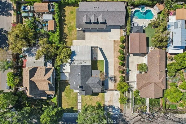 an aerial view of a house with outdoor space pool seating area and yard