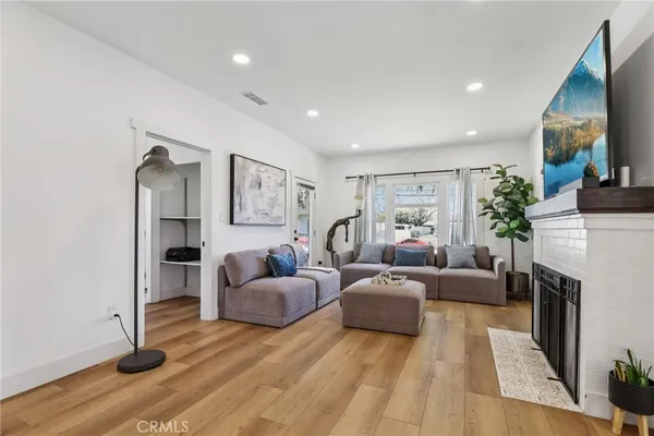 a living room with furniture a fireplace and a flat screen tv