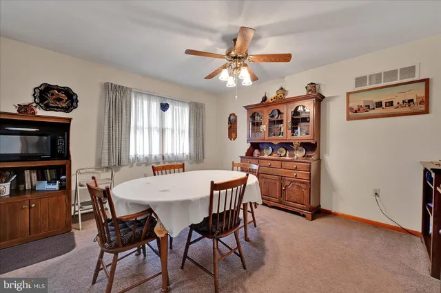 a view of a dining room with furniture and a window
