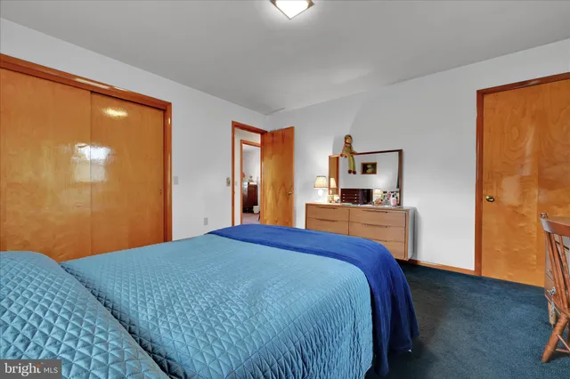 a bedroom with a bed and a lamp with window