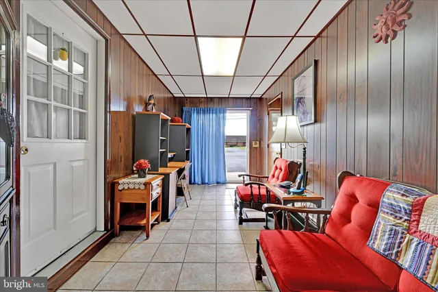 a backyard of a house with potted plants and large trees
