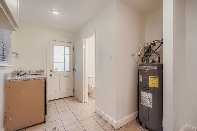 a view of a storage & utility room with closet window