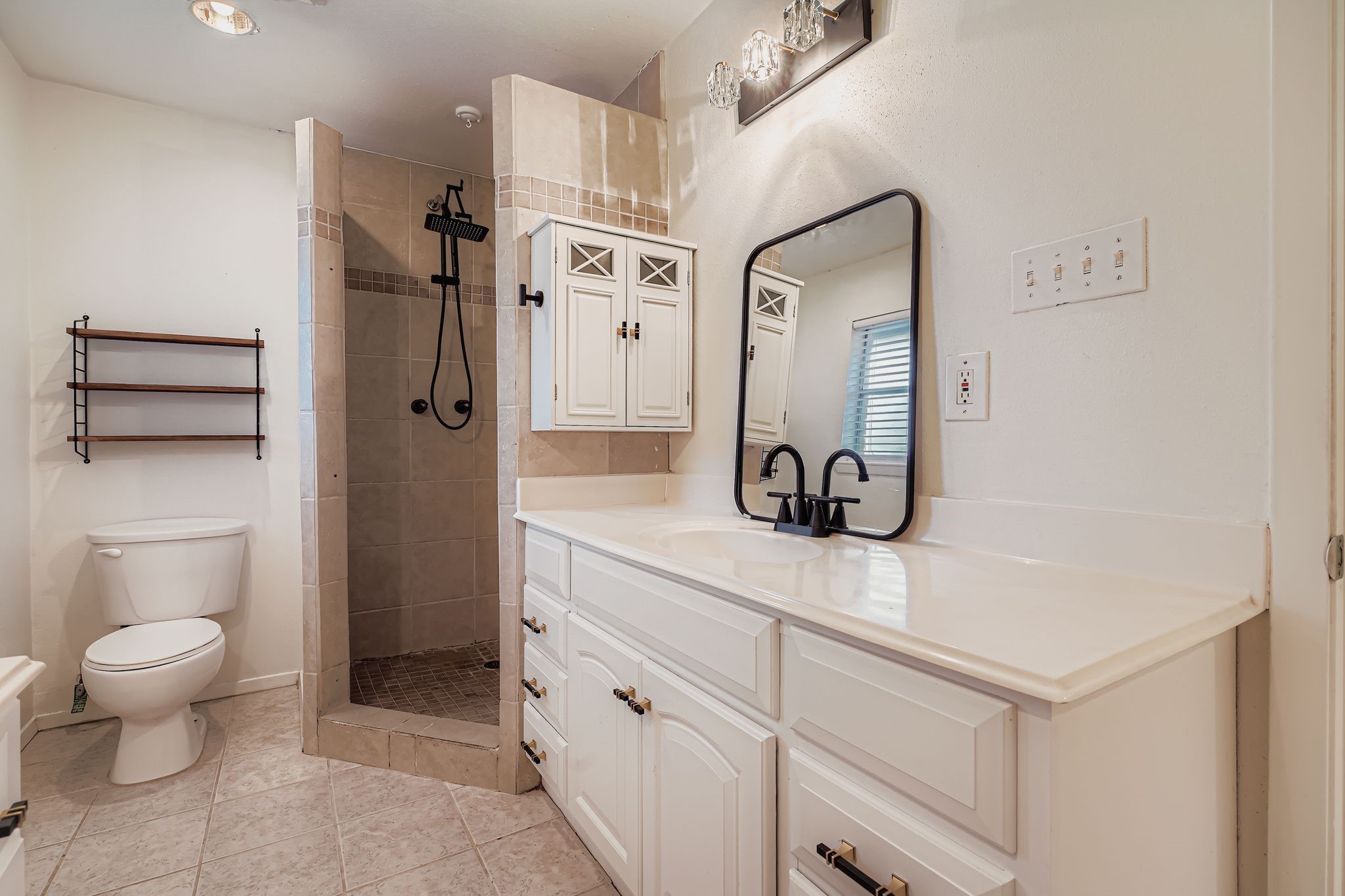 1411 Neptune Lane Houston, TX 77062 - Photo 14 of 22 a bathroom with a sink a toilet and a mirror