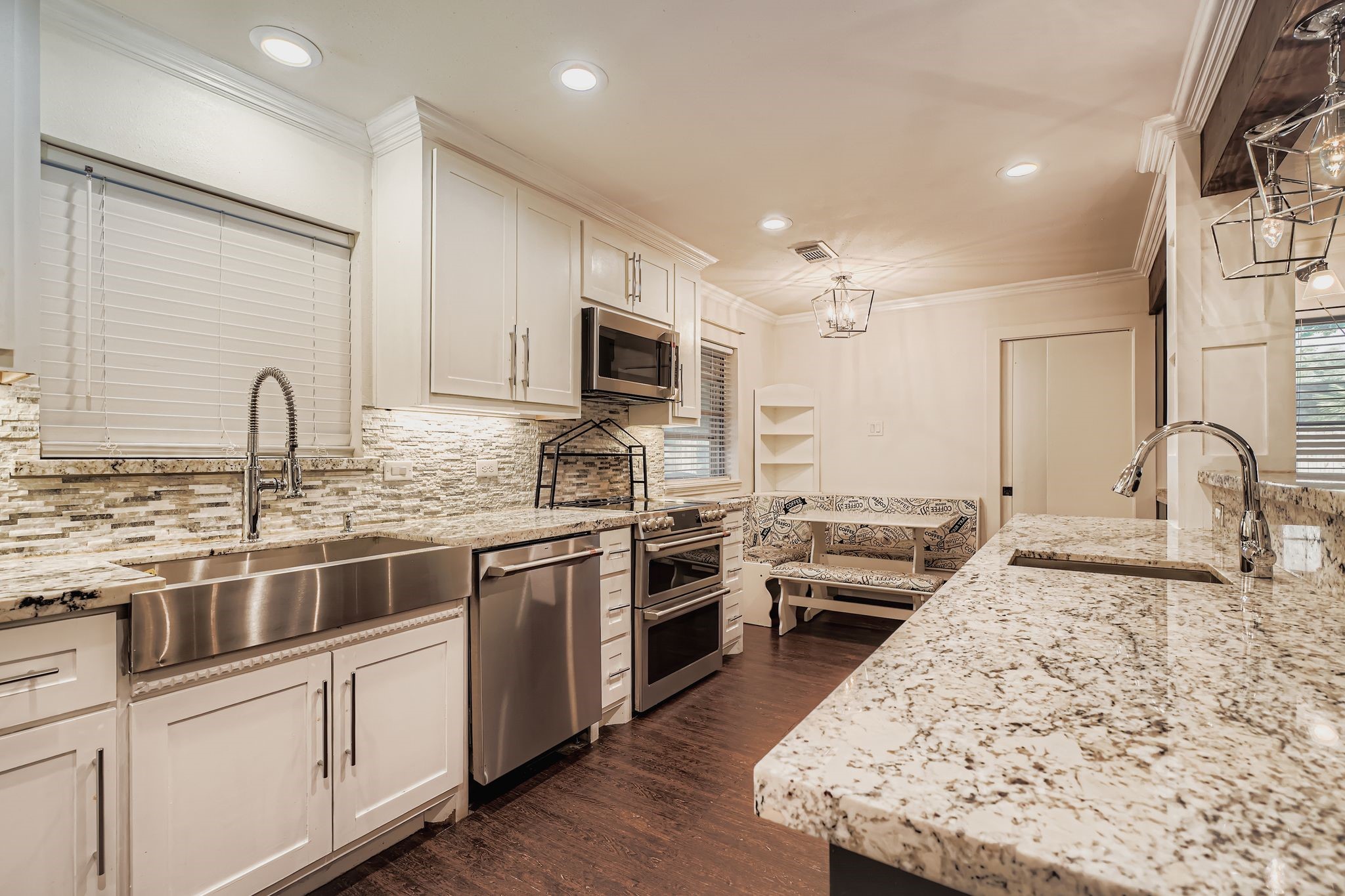 1411 Neptune Lane Houston, TX 77062 - Photo 9 of 22 a kitchen with stainless steel appliances granite countertop a stove top oven a sink a refrigerator with white cabinets and wooden floor