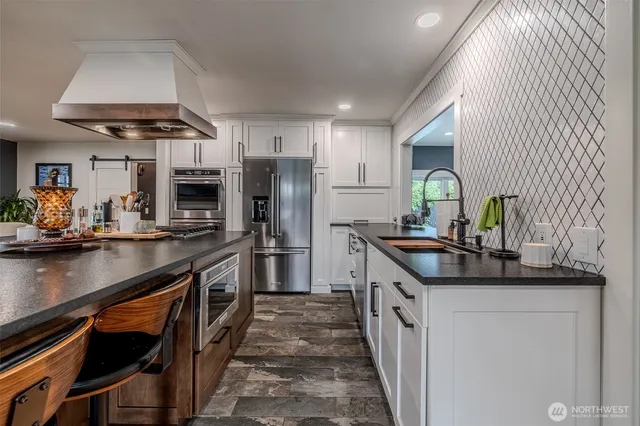 a kitchen with stainless steel appliances a sink stove and refrigerator