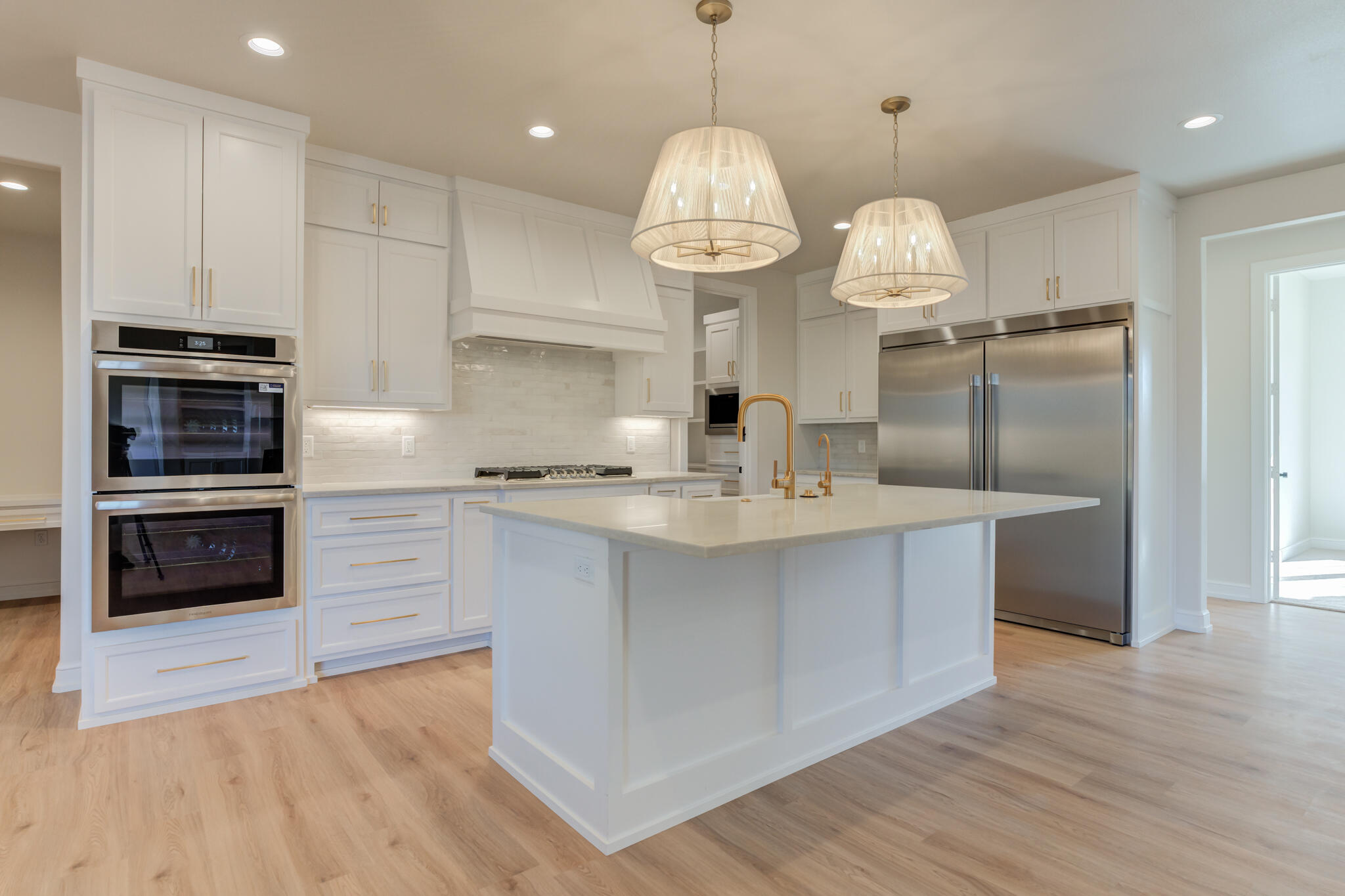 4602 140th Street Lubbock, TX 79424 - Photo 17 of 56 a kitchen with kitchen island granite countertop a stove a refrigerator a sink and a wooden floors