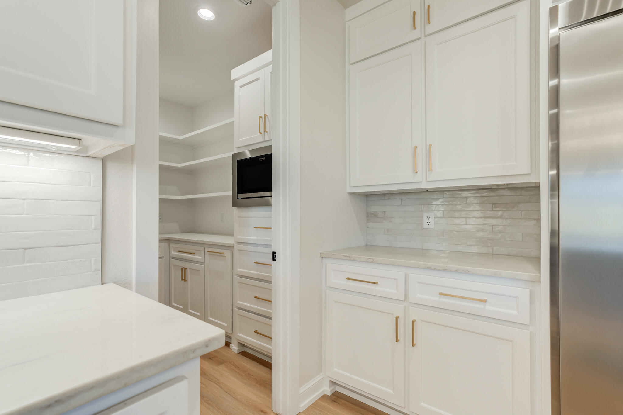 4602 140th Street Lubbock, TX 79424 - Photo 21 of 56 a kitchen with white cabinets and white appliances