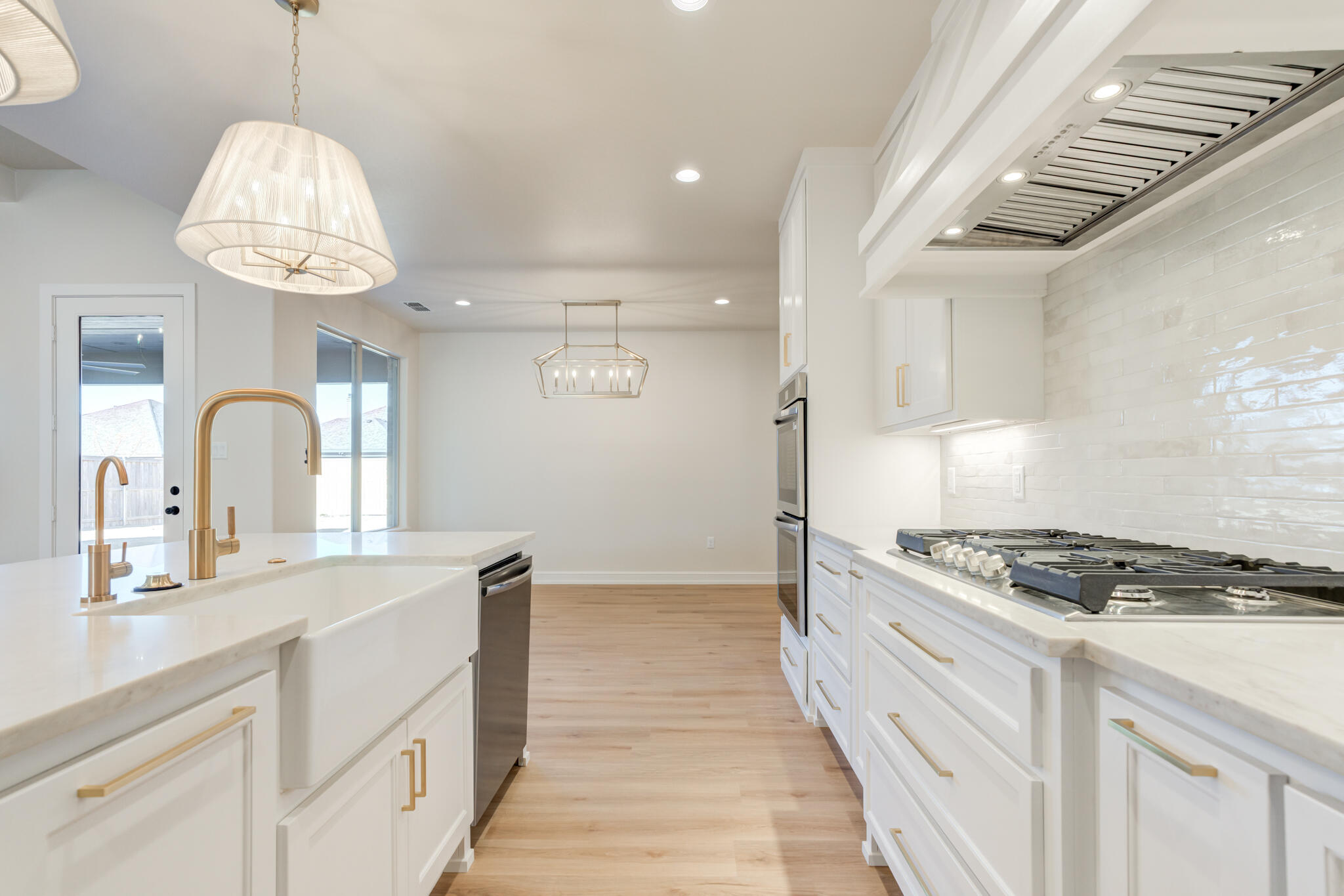 4602 140th Street Lubbock, TX 79424 - Photo 24 of 56 a kitchen with granite countertop a stove and white cabinets