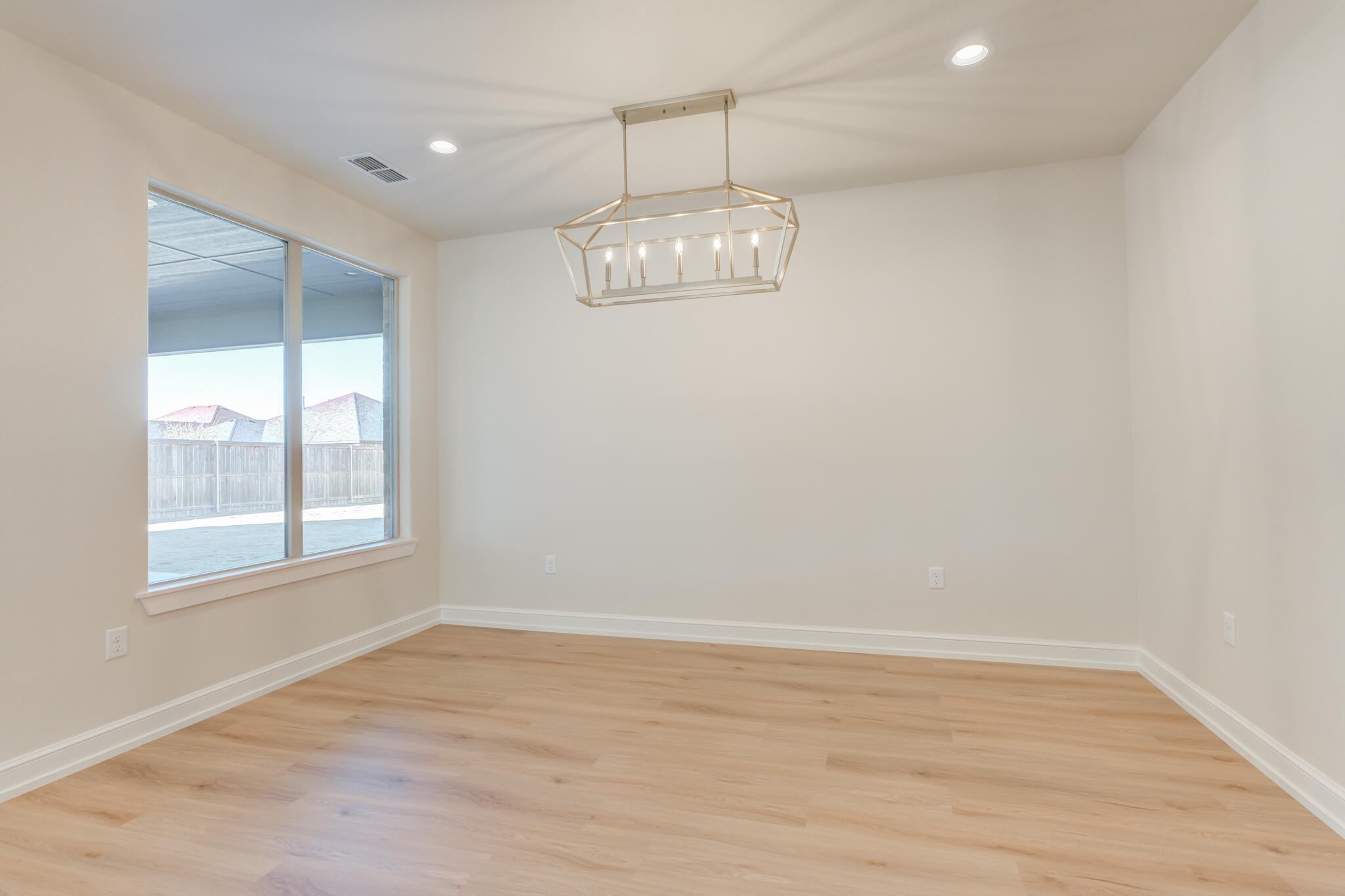 4602 140th Street Lubbock, TX 79424 - Photo 26 of 56 an empty room with wooden floor and windows