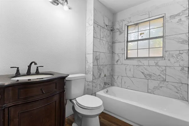 a bathroom with a sink a toilet and bathtub