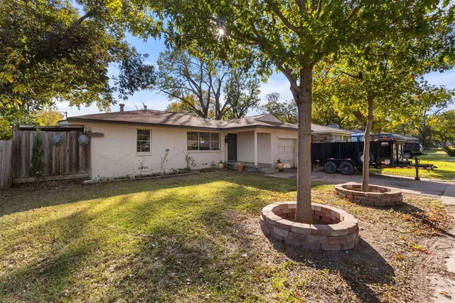 a view of a house with swimming pool and a yard