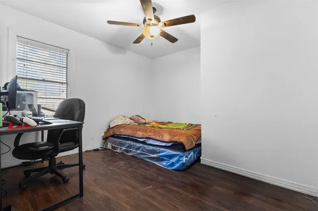 a bedroom with a bed and a desk