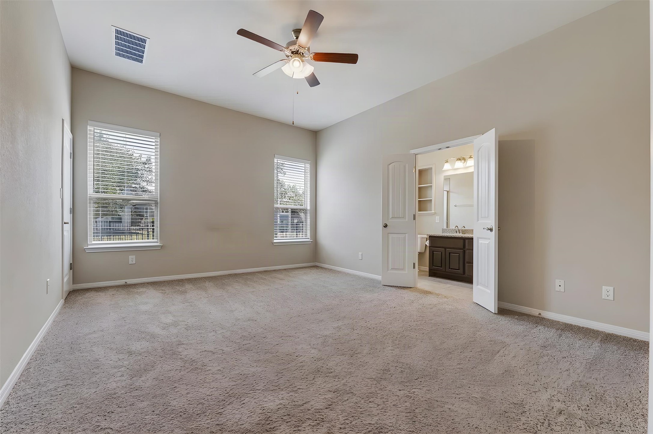162 Rains Kyle, TX 78640 - Photo 14 of 32 Primary bedroom featuring high vaulted ceilings, plush carpeting and a ceiling fan.