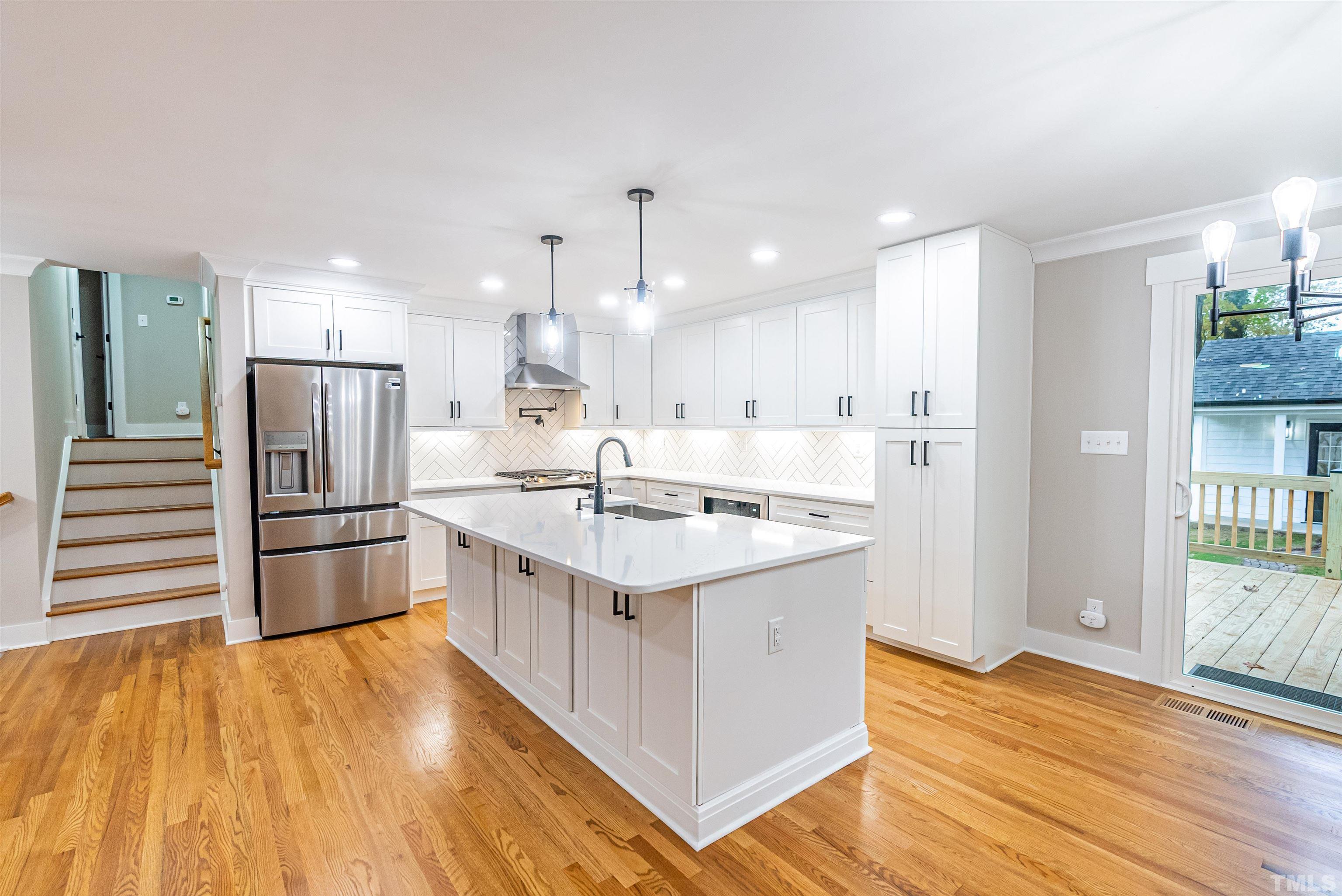 5405 Emerson Drive Raleigh, NC 27609 - Photo 11 of 46 a kitchen with stainless steel appliances granite countertop a sink stove and refrigerator