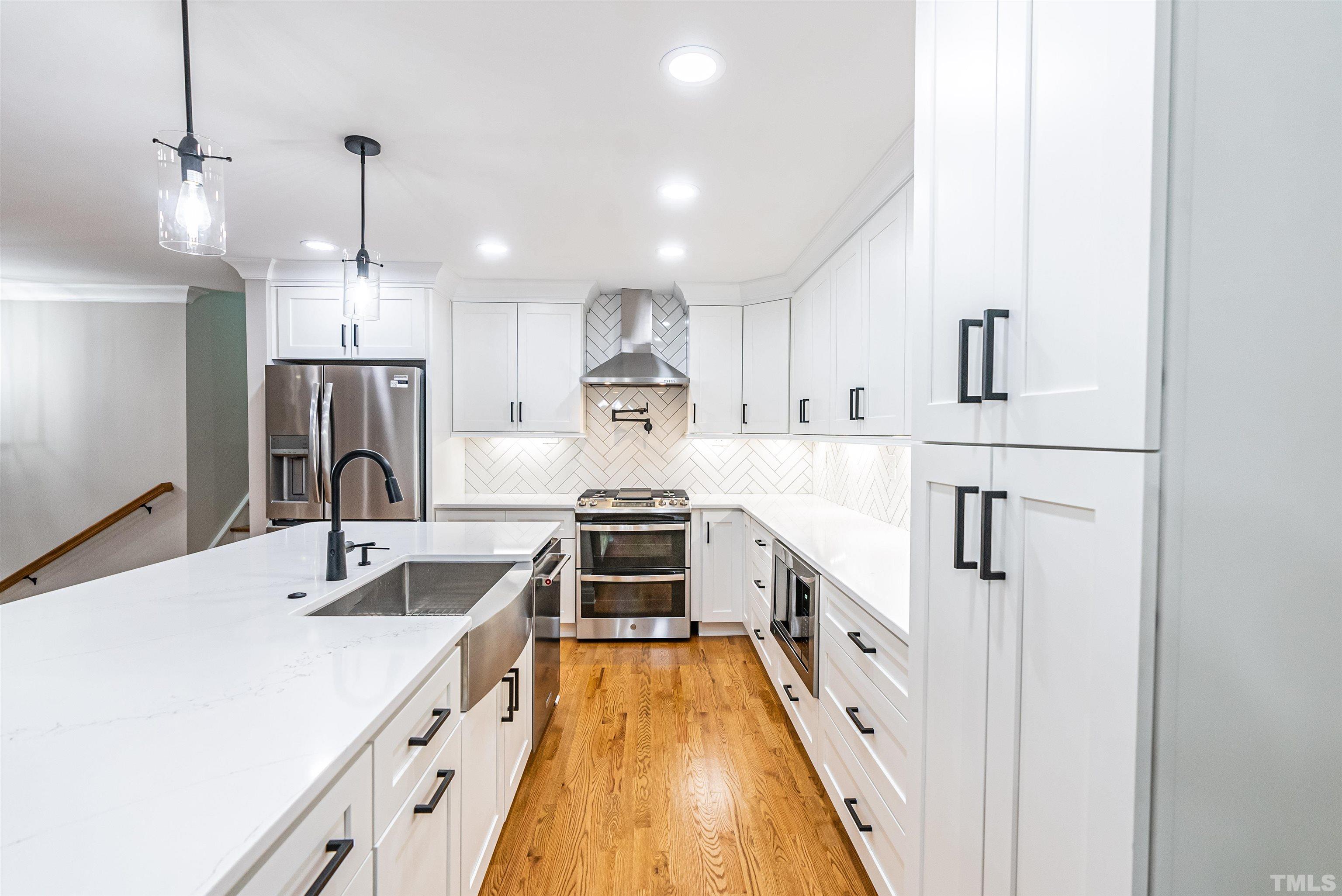 5405 Emerson Drive Raleigh, NC 27609 - Photo 14 of 46 a kitchen with kitchen island granite countertop a sink and refrigerator