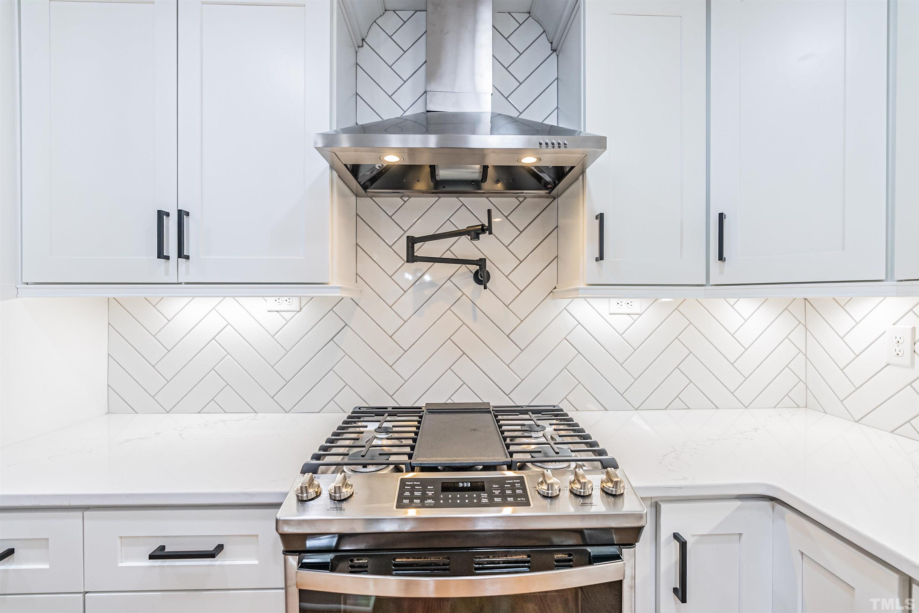 5405 Emerson Drive Raleigh, NC 27609 - Photo 15 of 46 a stove top oven sitting inside of a kitchen