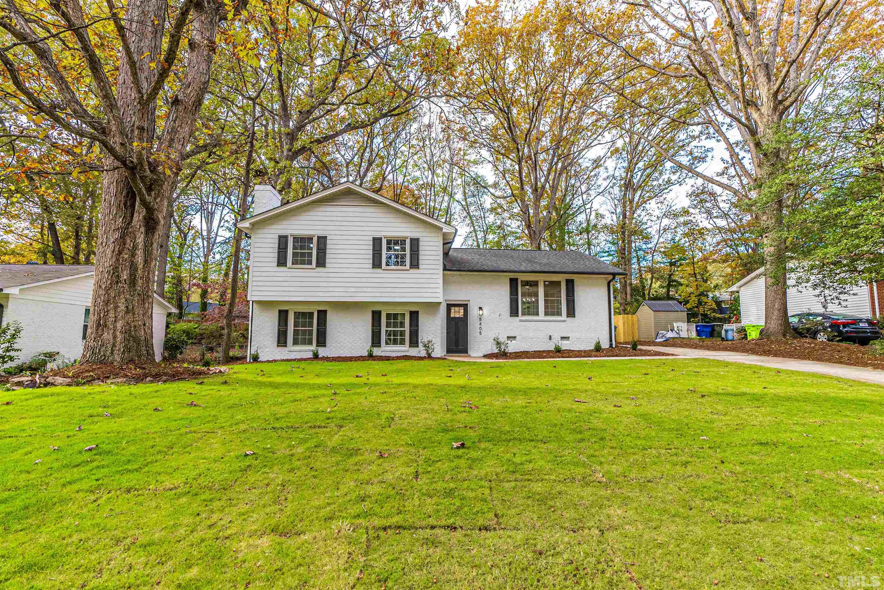 5405 Emerson Drive Raleigh, NC 27609 - Photo 2 of 46 a front view of a house with a garden and trees