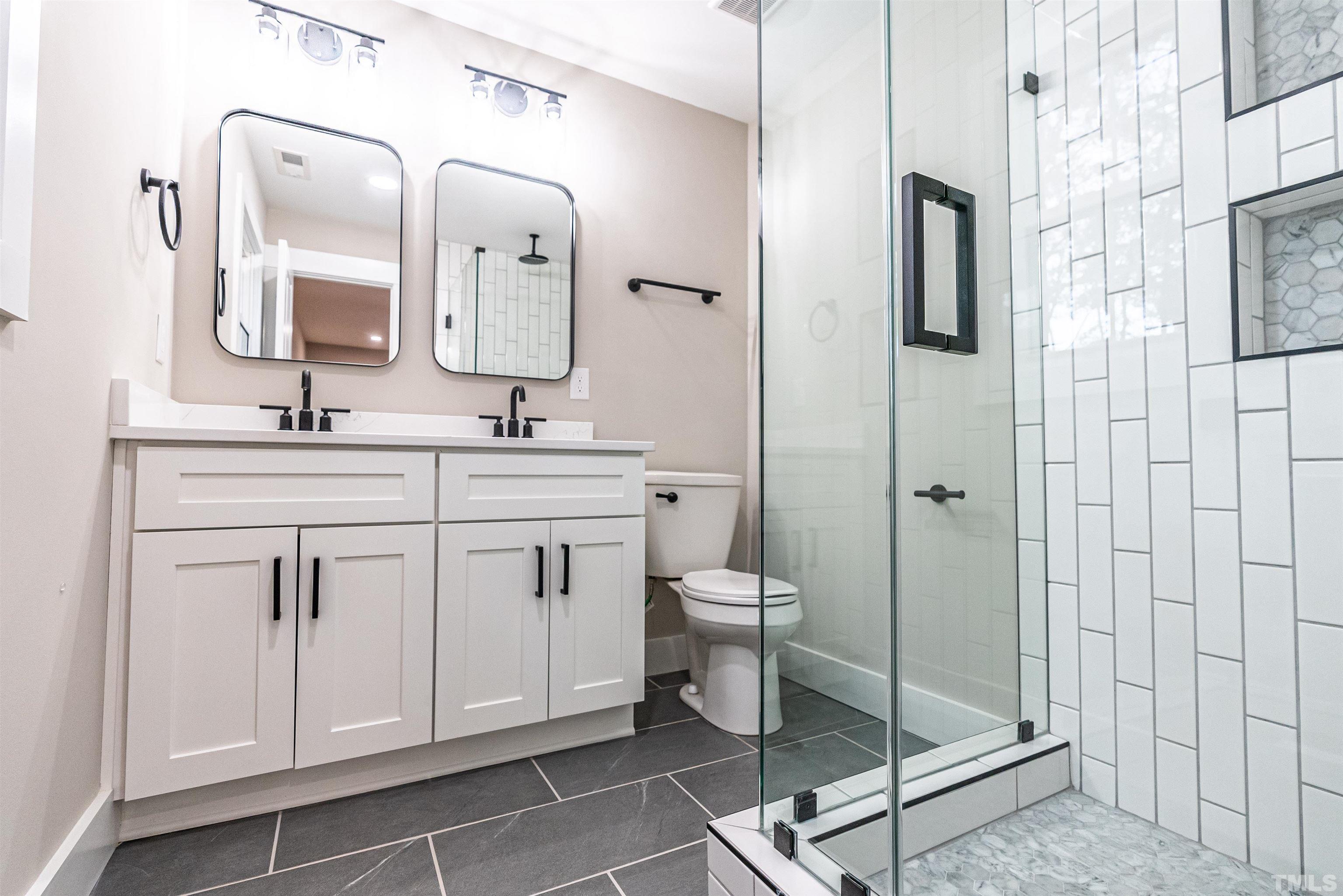 5405 Emerson Drive Raleigh, NC 27609 - Photo 21 of 46 a spacious bathroom with a double vanity sink mirror and toilet