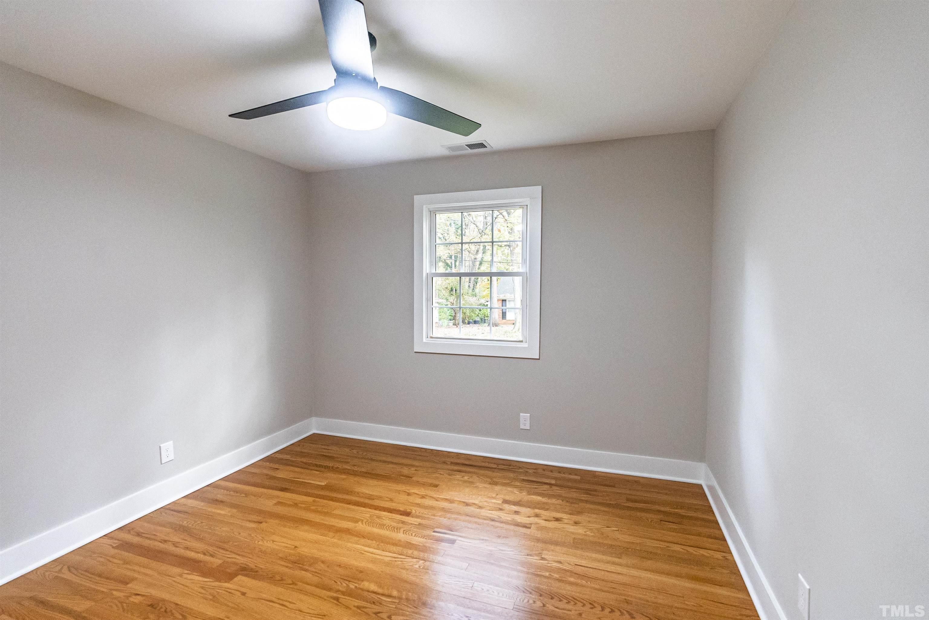 5405 Emerson Drive Raleigh, NC 27609 - Photo 23 of 46 wooden floor in an empty room with a window