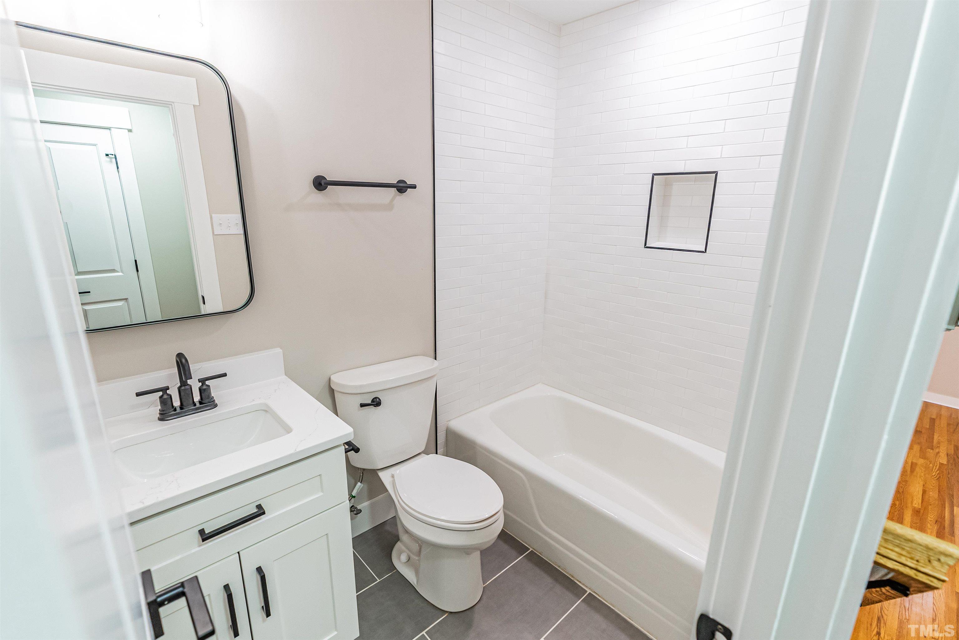5405 Emerson Drive Raleigh, NC 27609 - Photo 25 of 46 a bathroom with a sink a toilet and shower