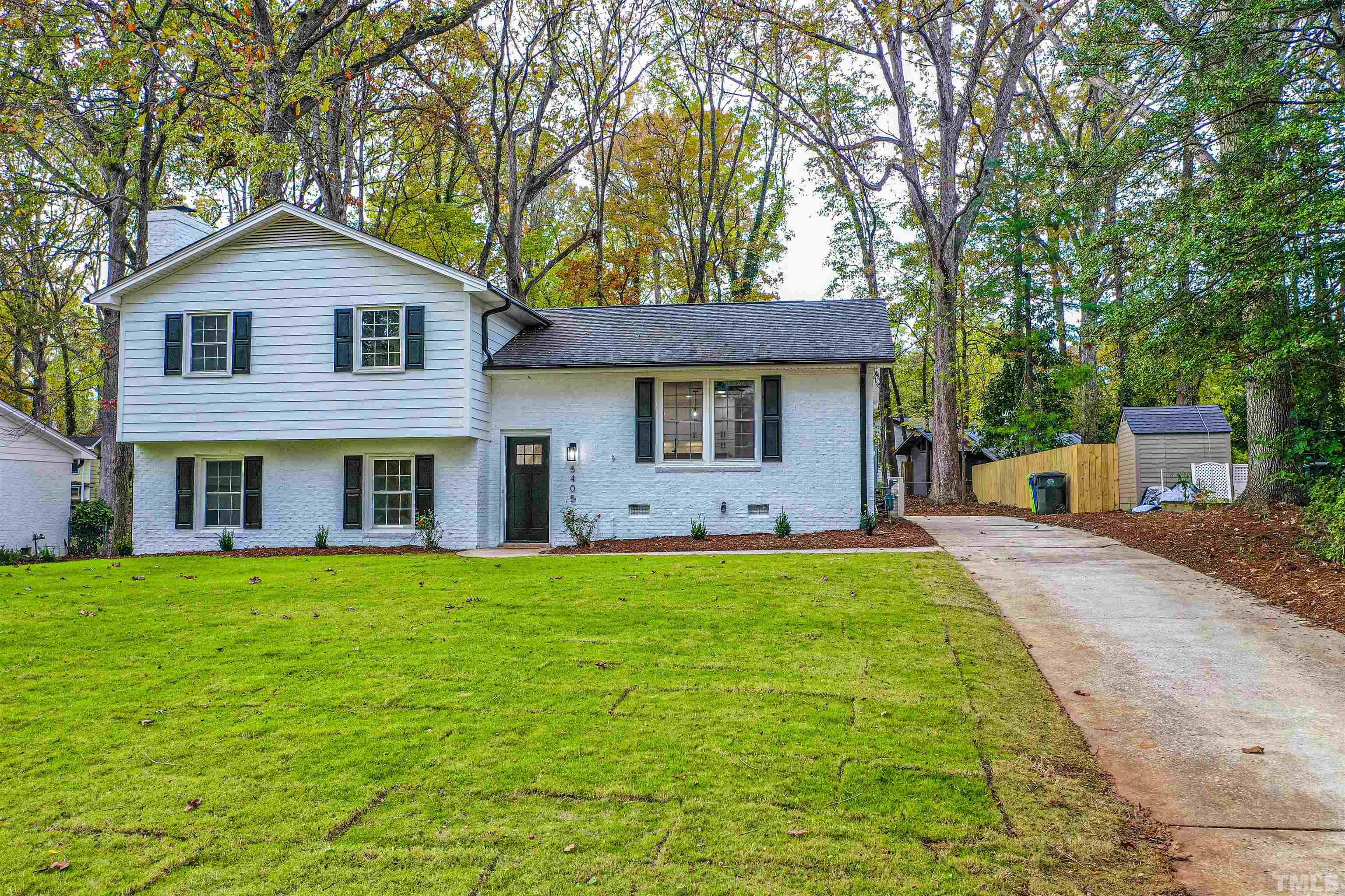 5405 Emerson Drive Raleigh, NC 27609 - Photo 3 of 46 a front view of a house with a yard and trees