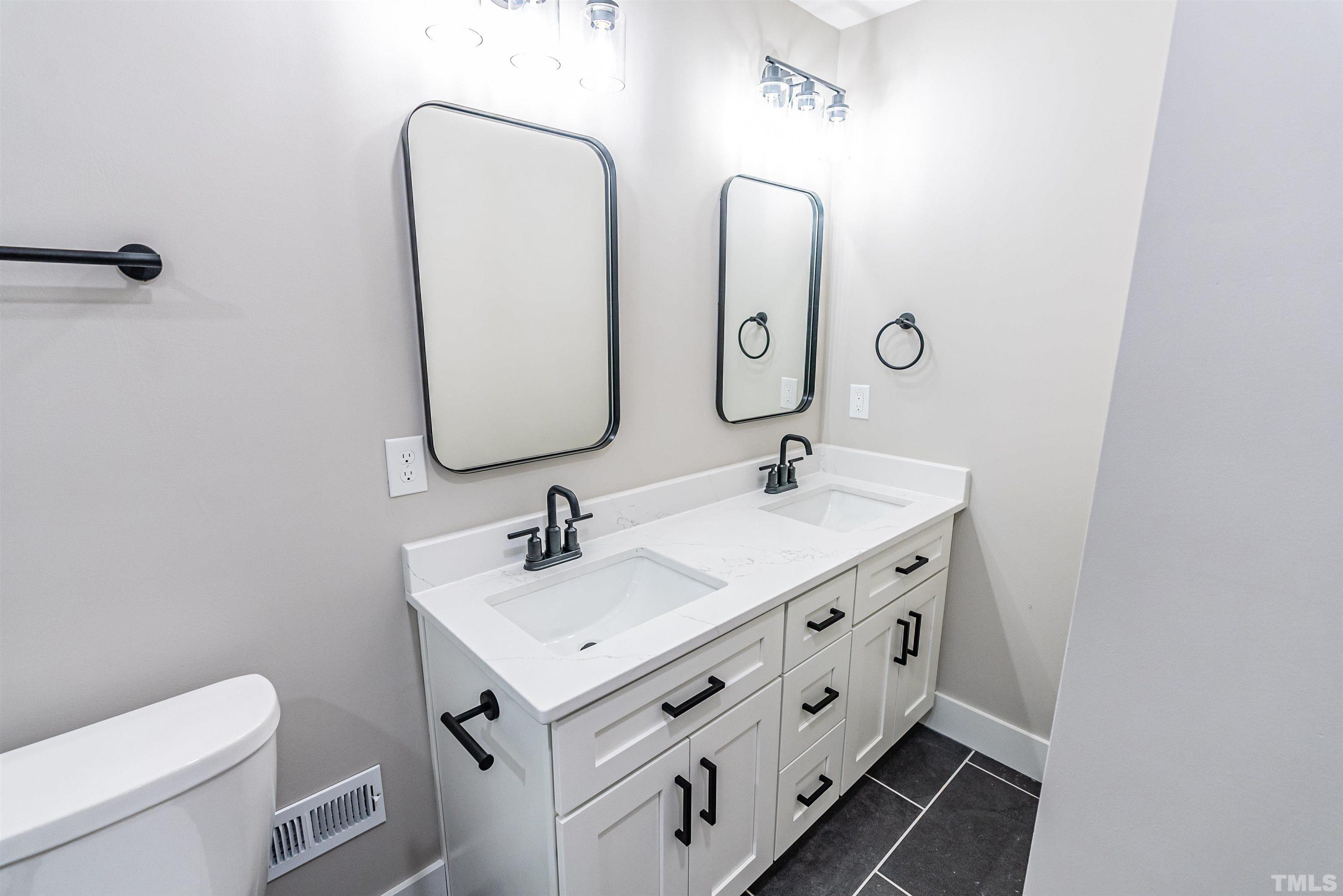 5405 Emerson Drive Raleigh, NC 27609 - Photo 31 of 46 a bathroom with 2 sink and a mirror