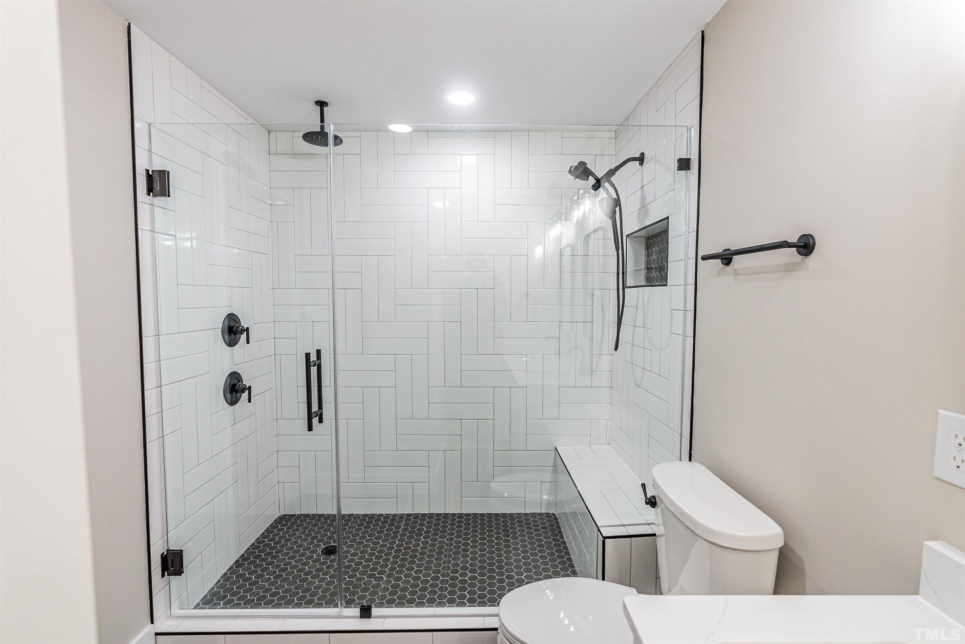 5405 Emerson Drive Raleigh, NC 27609 - Photo 32 of 46 a bathroom with a shower a toilet and a shower