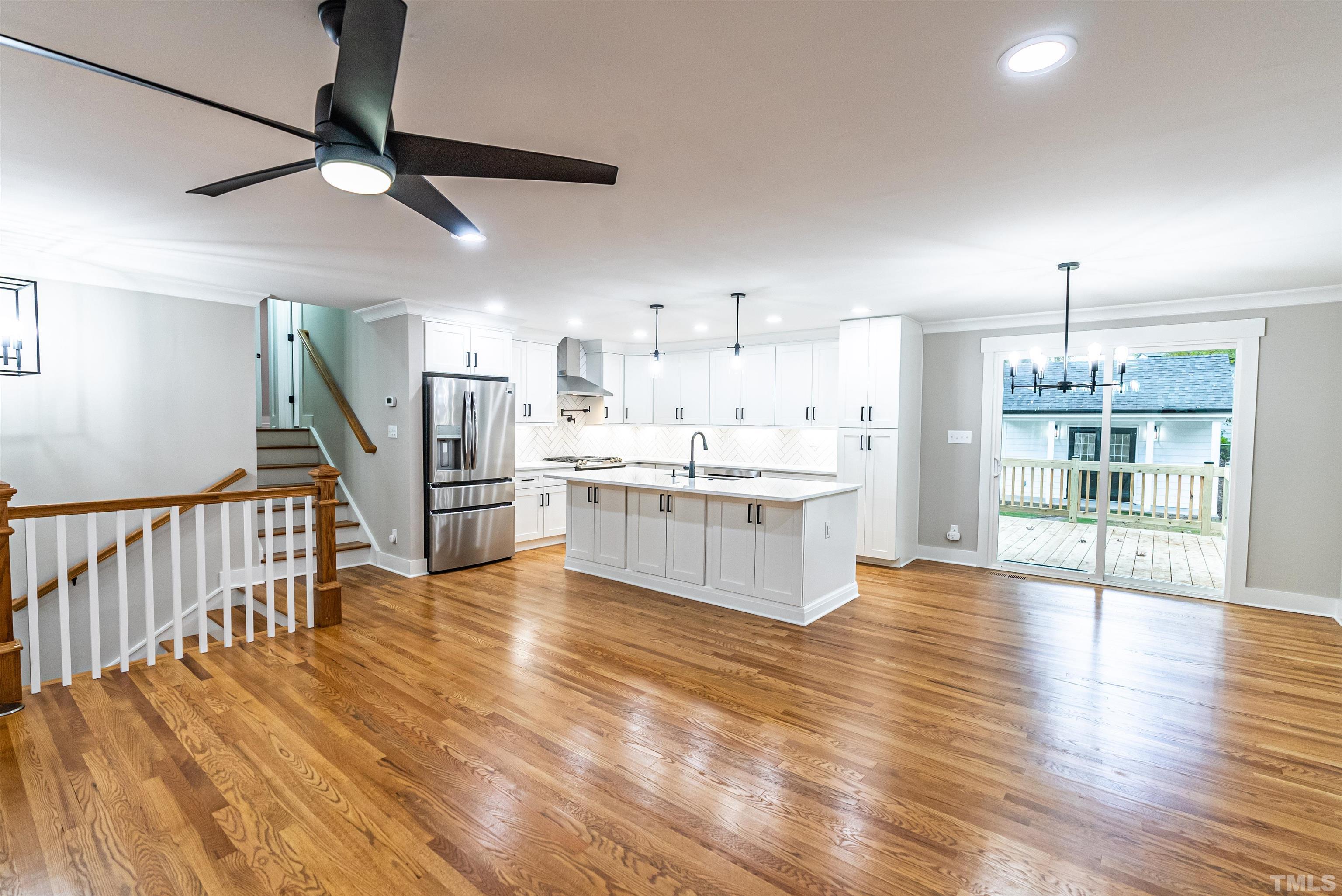5405 Emerson Drive Raleigh, NC 27609 - Photo 7 of 46 a large white kitchen with wooden floors and a fireplace
