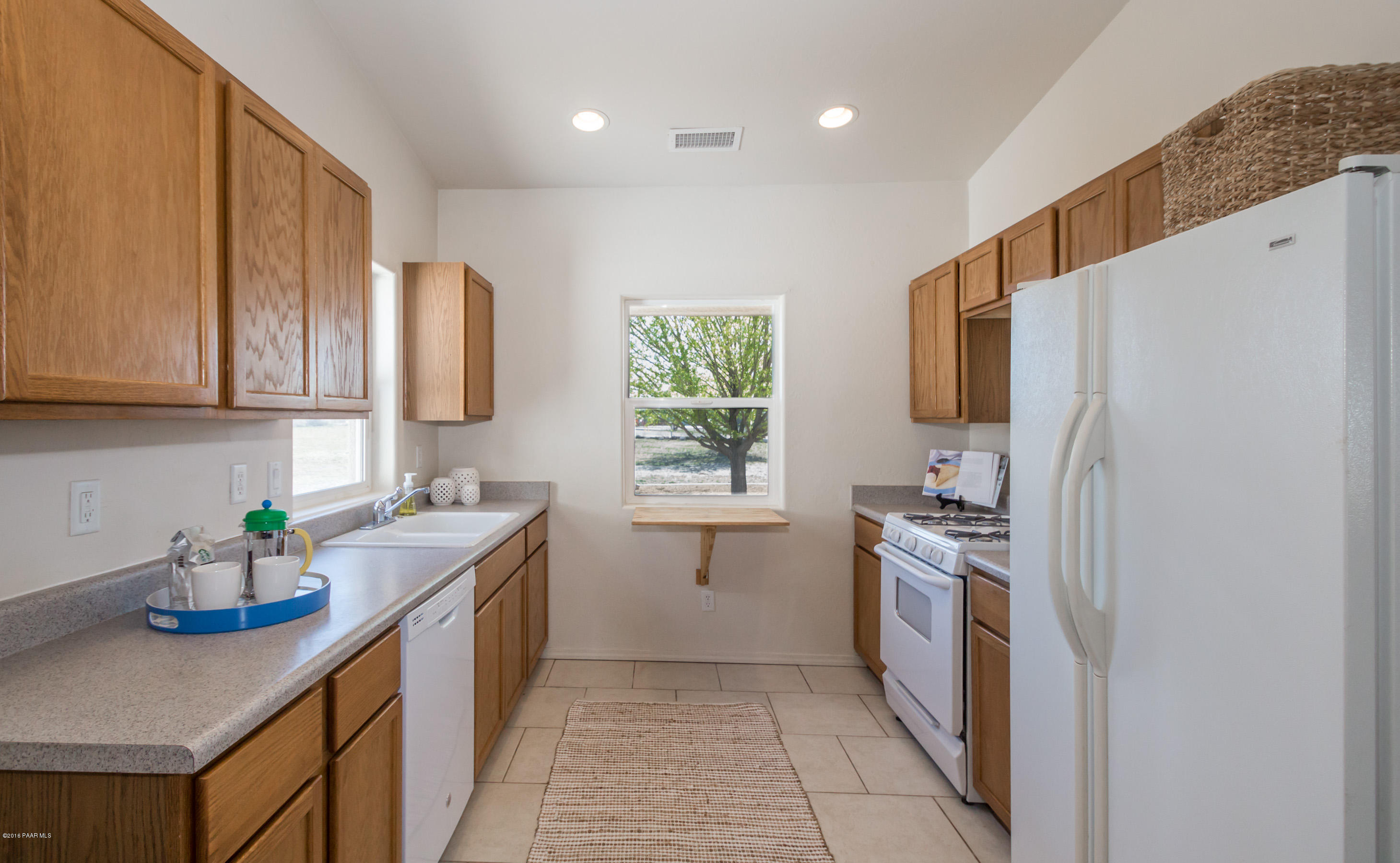 25800 Poppy Road Paulden, AZ 86334 - Photo 3 of 15 a kitchen with stainless steel appliances granite countertop a sink stove and refrigerator