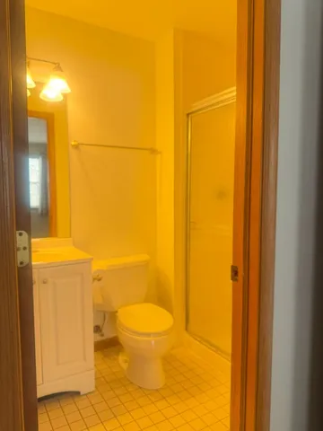 a bathroom with a toilet and a shower