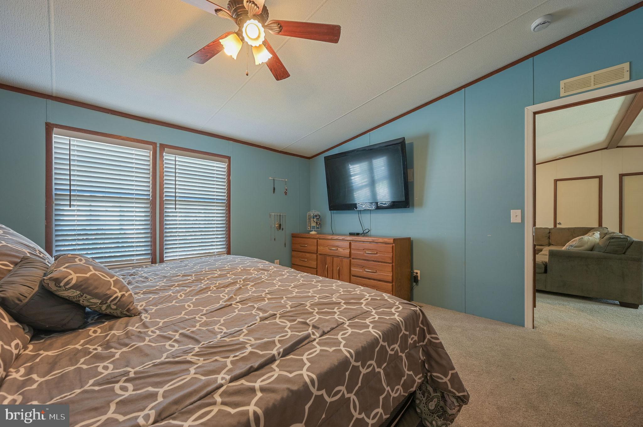33 Hedgerow Hollow Road, Unit 33 Smyrna, DE 19977 - Photo 12 of 20 a bedroom with a bed and a flat screen tv