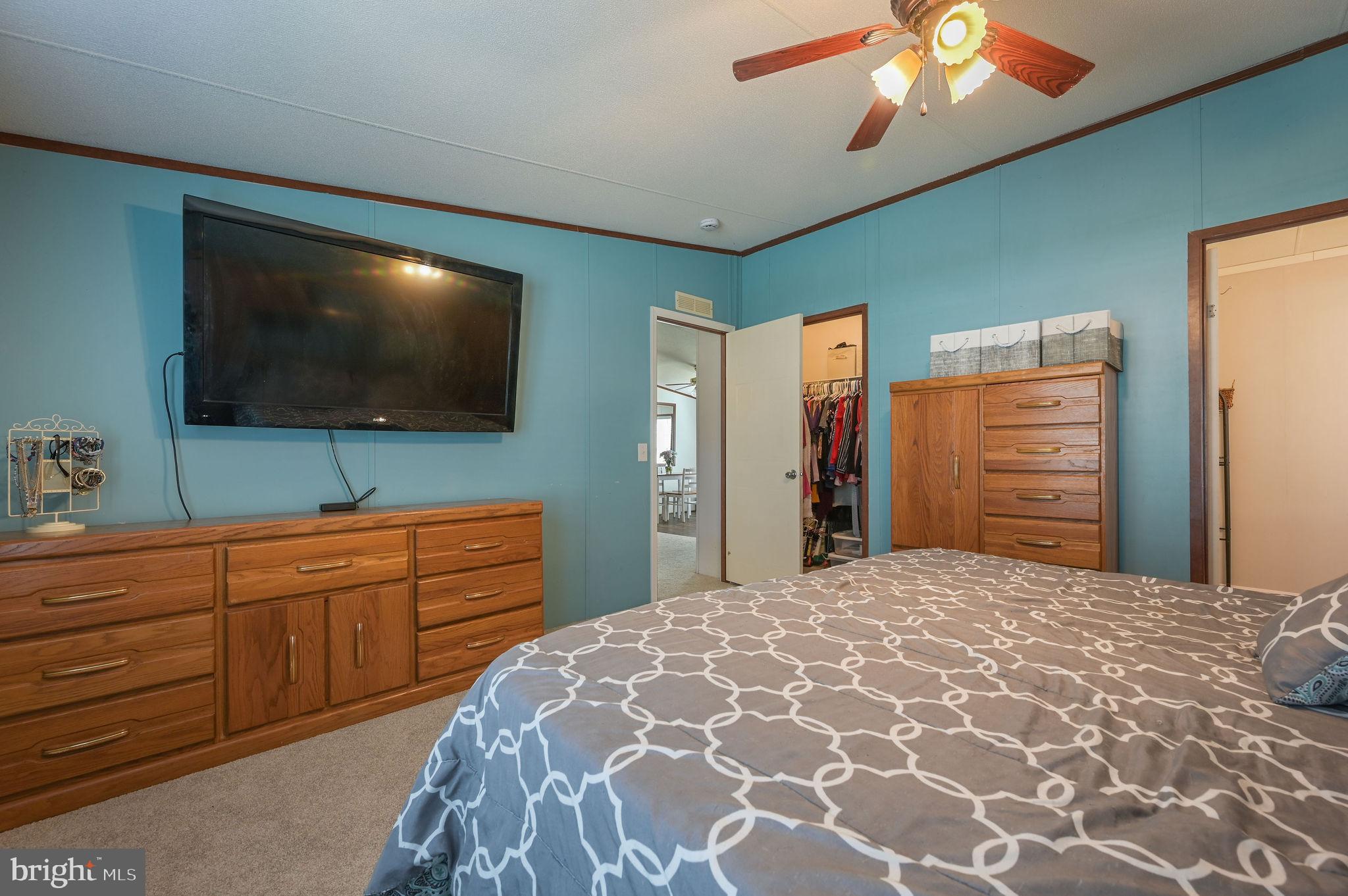 33 Hedgerow Hollow Road, Unit 33 Smyrna, DE 19977 - Photo 13 of 20 a bedroom with a bed and a flat screen tv