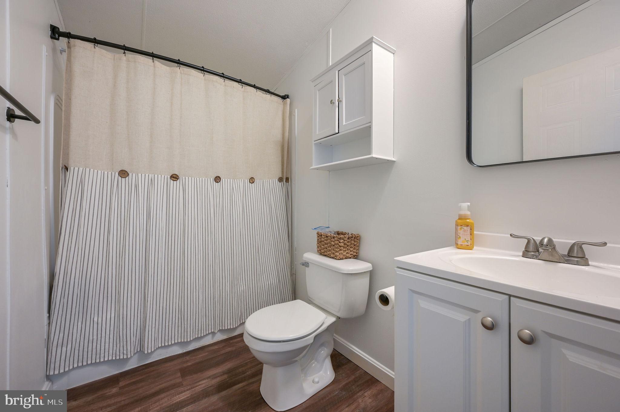 33 Hedgerow Hollow Road, Unit 33 Smyrna, DE 19977 - Photo 19 of 20 a white toilet sitting next to a bathroom sink