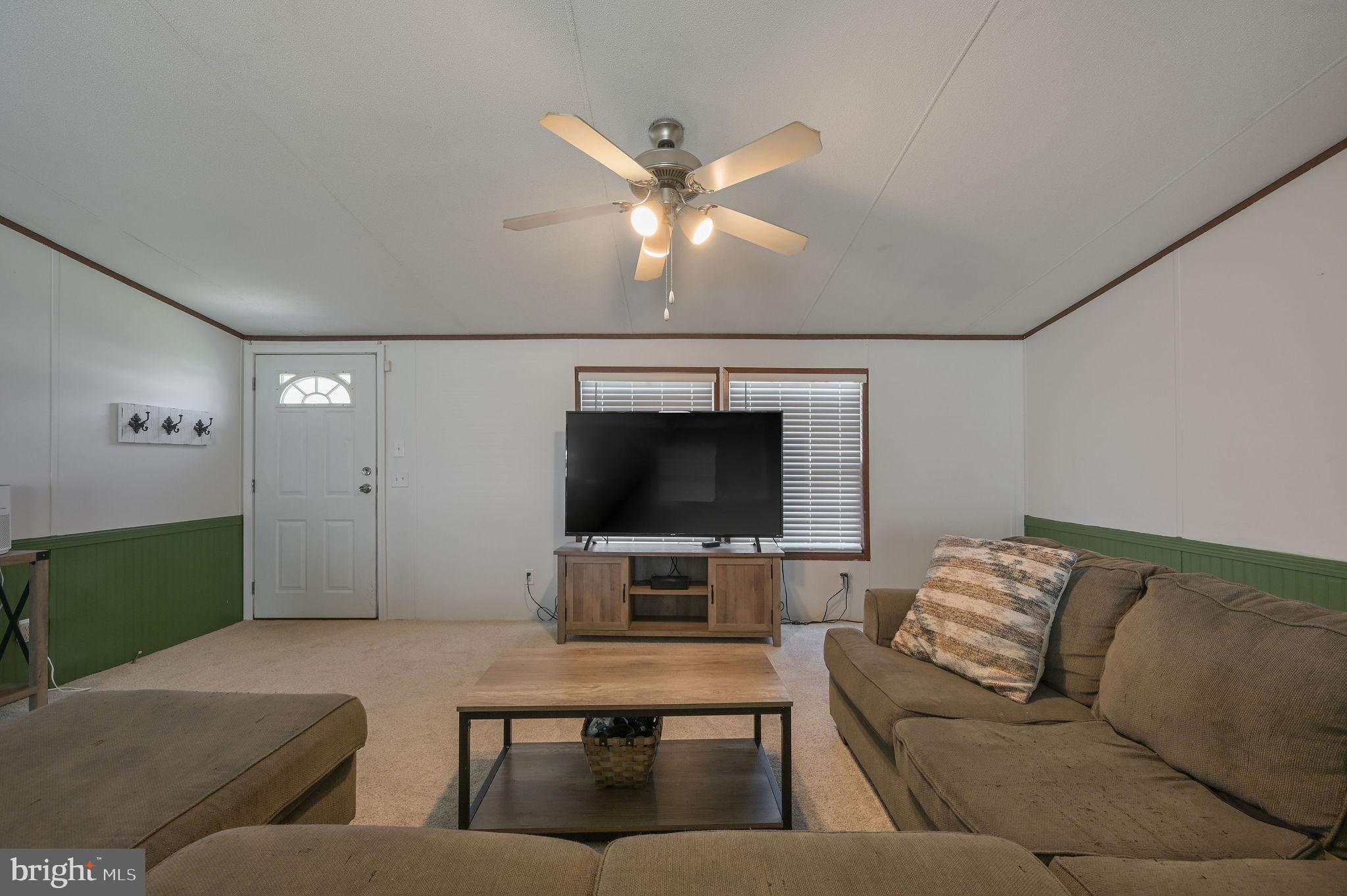 33 Hedgerow Hollow Road, Unit 33 Smyrna, DE 19977 - Photo 3 of 20 a living room with furniture and a flat screen tv