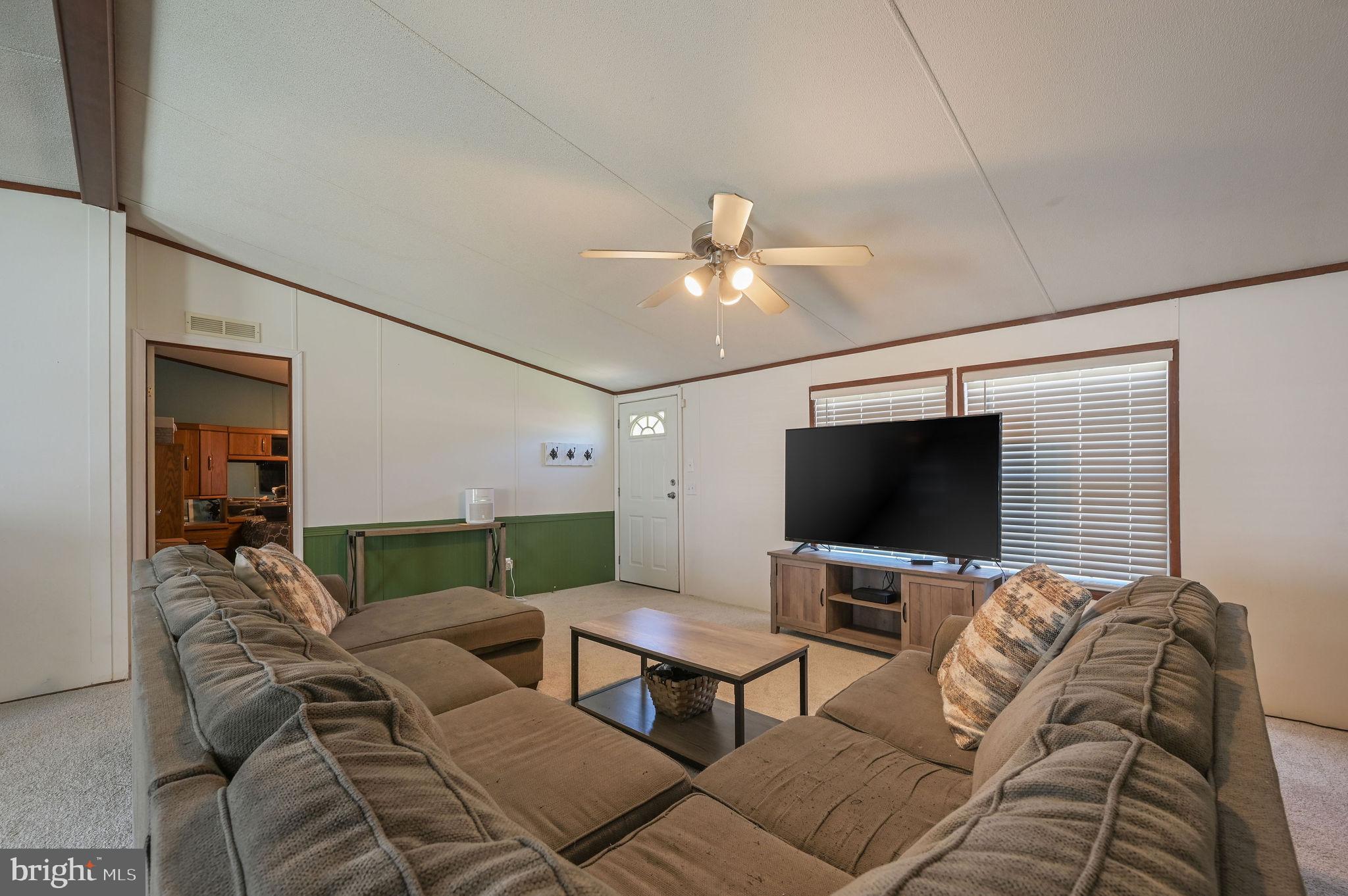 33 Hedgerow Hollow Road, Unit 33 Smyrna, DE 19977 - Photo 4 of 20 a living room with furniture and a flat screen tv