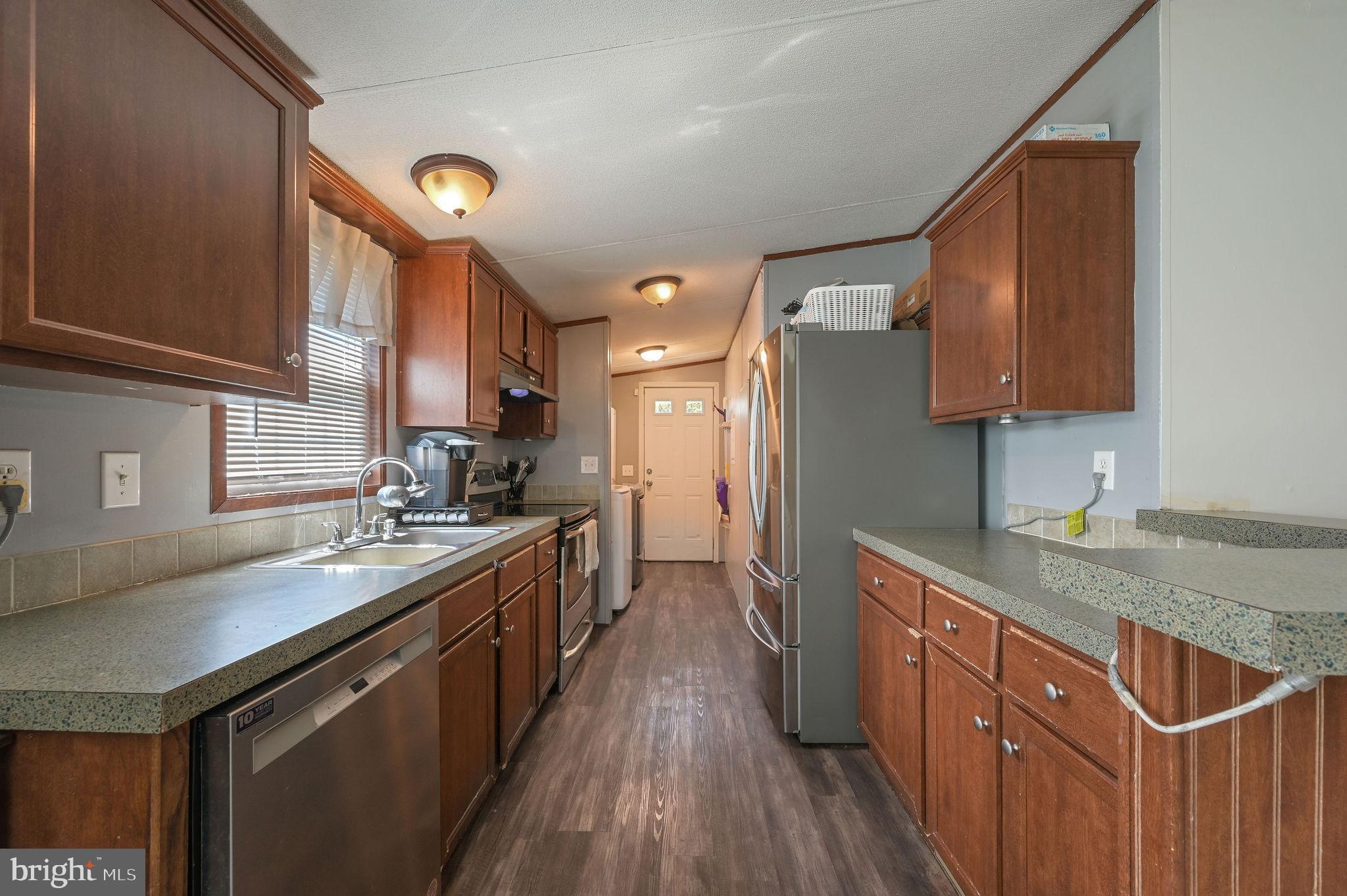33 Hedgerow Hollow Road, Unit 33 Smyrna, DE 19977 - Photo 8 of 20 a kitchen with stainless steel appliances granite countertop a sink stove and refrigerator