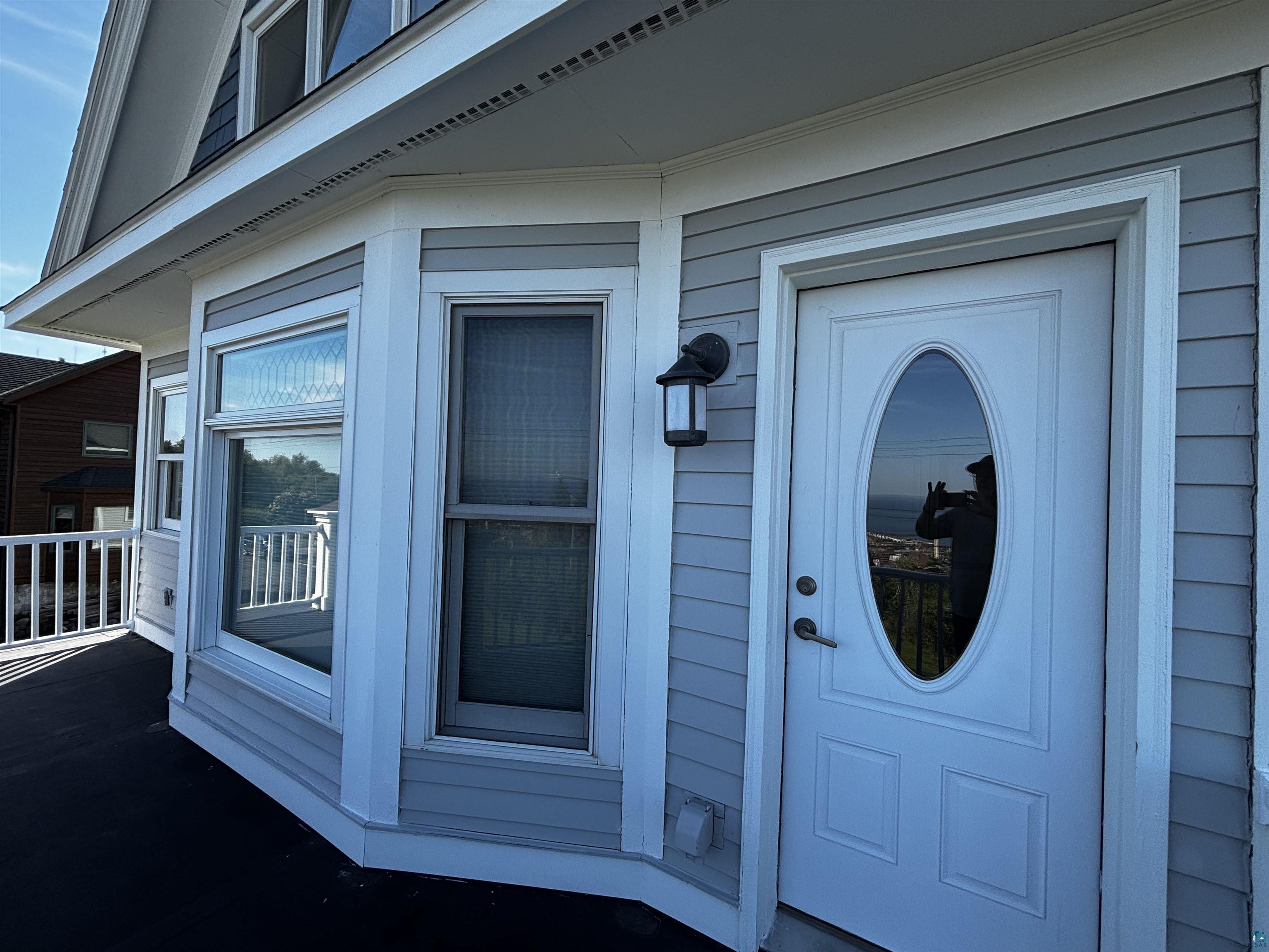 13 West 8th Street Duluth, MN 55806 - Photo 31 of 57 Light gray horizontal siding exterior with white trim