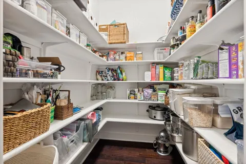 a kitchen with cabinets and wooden floor