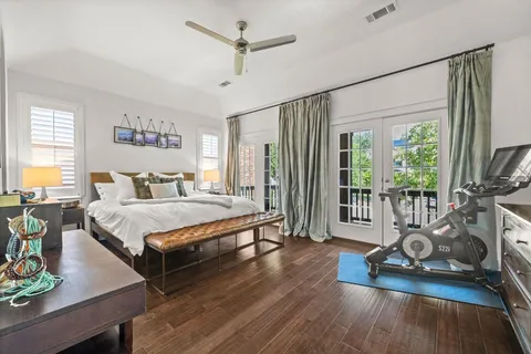 a kitchen with kitchen island granite countertop a stove a sink a dining table and chairs with wooden floor