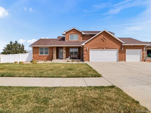 a front view of a house with a yard