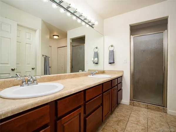 a bathroom with a sink double vanity and a mirror