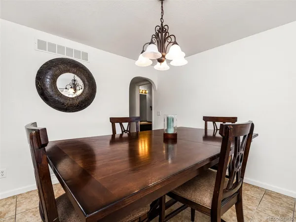 a view of a dining room with furniture and chandelier