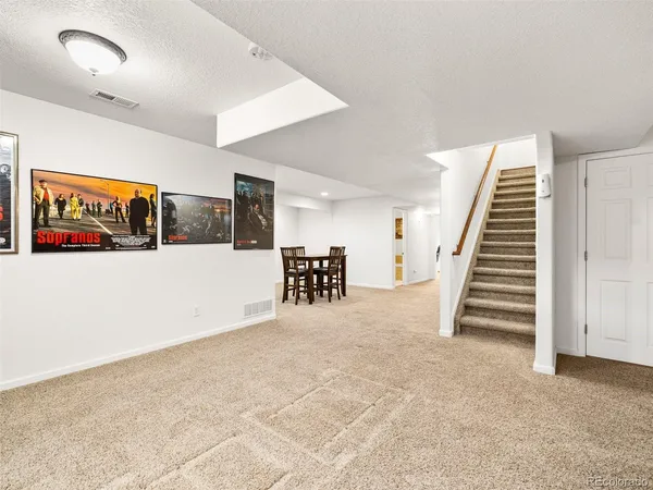 a view of a livingroom with stairs and furniture