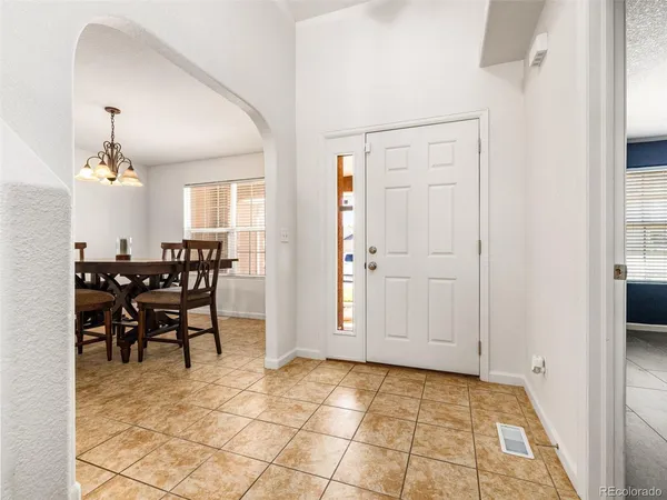 a view of a dining room with furniture and a chandelier