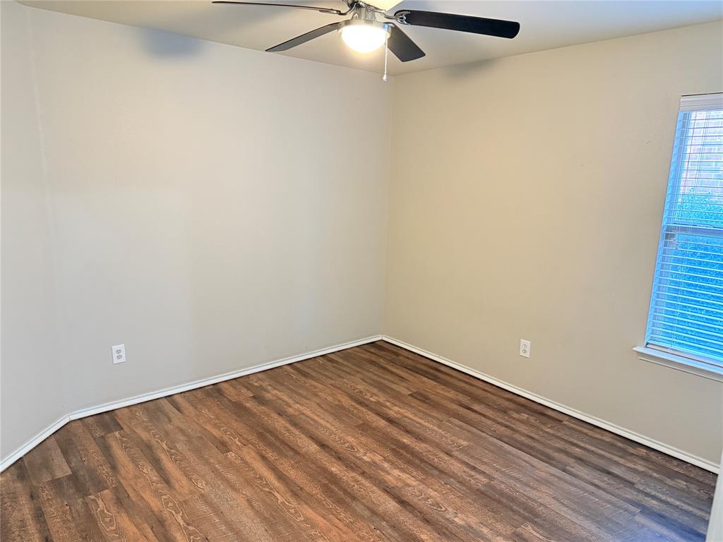 1117 Bent Tree Road Royse City, TX 75189 - Photo 12 of 22 Spare room with dark wood-style flooring and a ceiling fan