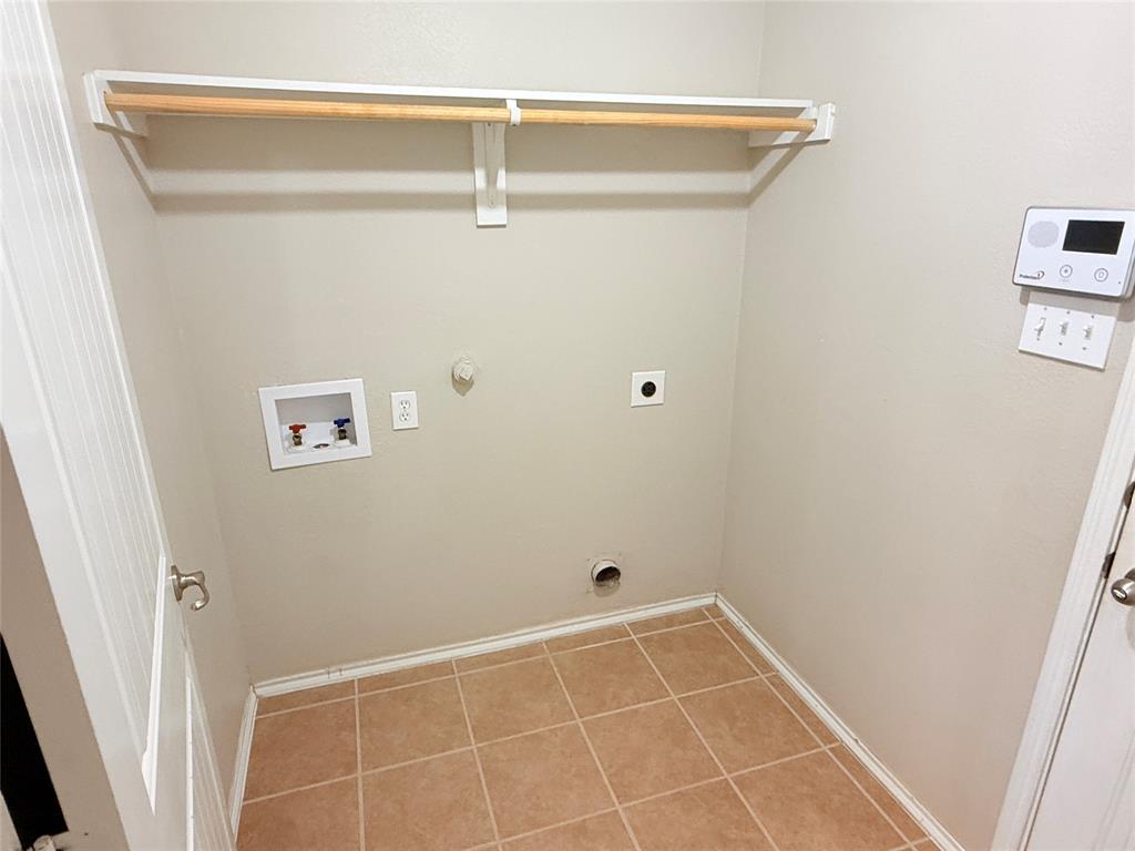 1117 Bent Tree Road Royse City, TX 75189 - Photo 15 of 22 Laundry room with hookup for a gas dryer, hookup for a washing machine, electric dryer hookup, and light tile patterned flooring