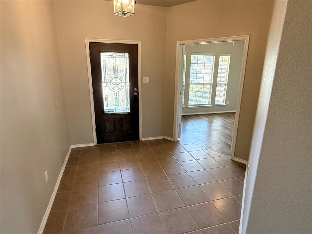 1117 Bent Tree Road Royse City, TX 75189 - Photo 3 of 22 Foyer entrance with baseboards and tile patterned flooring
