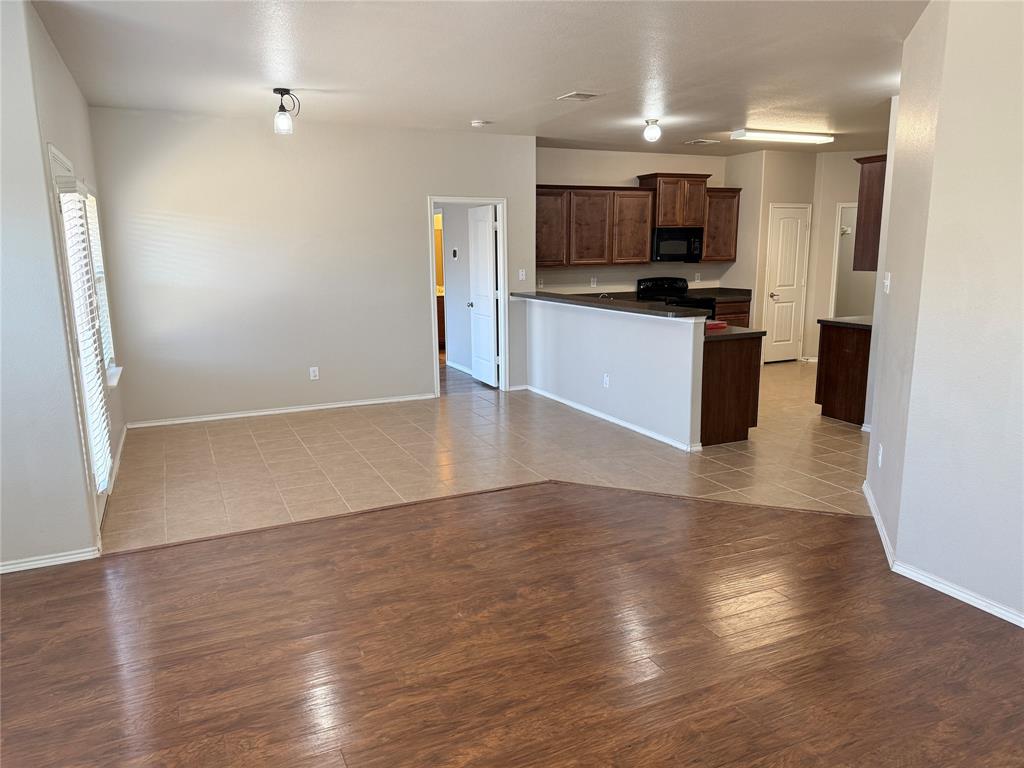 1117 Bent Tree Road Royse City, TX 75189 - Photo 22 of 22 Kitchen with dark countertops, open floor plan, and light wood-style floors