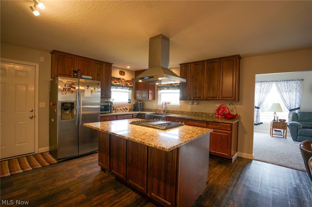 1325 County Line Road Hopewell, OH 43746 - Photo 2 of 45 Kitchen featuring stainless steel appliances, a kitchen island, island range hood, light stone countertops, and dark wood finished floors